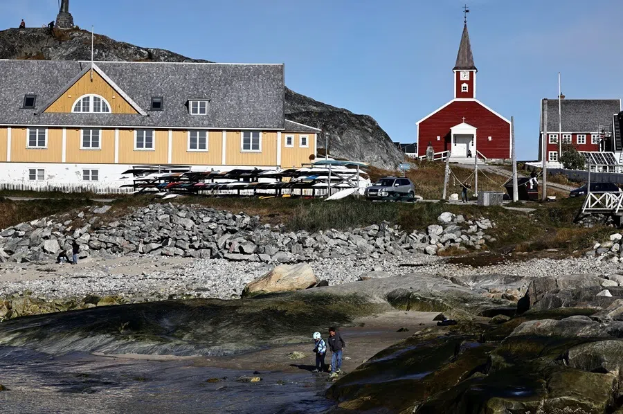 Two children play on the beach in the old harbour area of Nuuk, Greenland, 22 September 2026.