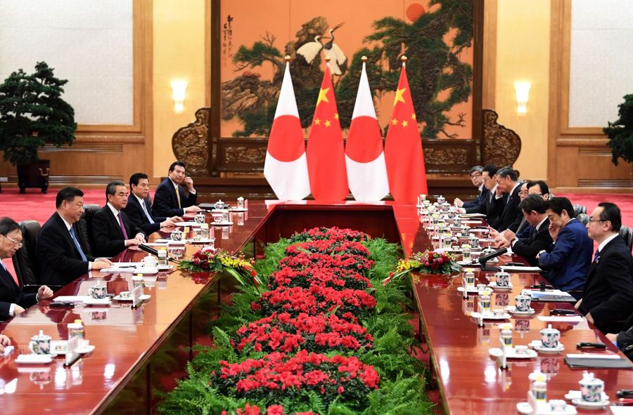 Japan's Prime Minister Shinzo Abe (second, right) talks to China's President Xi Jinping (second, left) during a meeting at the Great Hall of the People in Beijing on 23 December 2019. Xi is expected to visit Japan later this year. (Noel Celis/POOL/AFP)