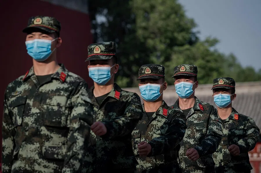 People's Liberation Army (PLA) soldiers march next to the entrance to the Forbidden City (left) after the opening session of the National People's Congress (NPC) in Beijing on 22 May 2020. (Nicolas Asfouri/AFP)