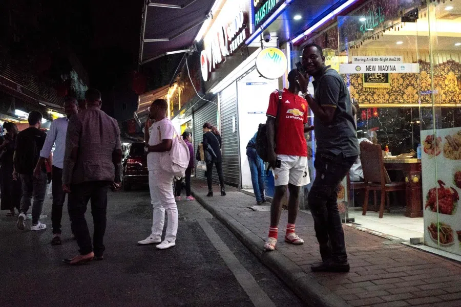 This file photo taken on March 2, 2018 shows people gathering on a street in the "Little Africa" district in Guangzhou, the capital of southern China's Guangdong province. Africans in southern China's largest city say they have become targets of suspicion and subjected to forced evictions, arbitrary quarantines and mass coronavirus testing. (Fred Dufour/AFP)
