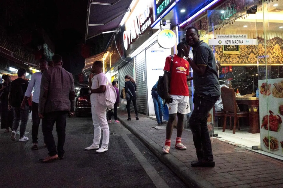 This file photo taken on March 2, 2018 shows people gathering on a street in the "Little Africa" district in Guangzhou, the capital of southern China's Guangdong province. Africans in southern China's largest city say they have become targets of suspicion and subjected to forced evictions, arbitrary quarantines and mass coronavirus testing. (Fred Dufour/AFP)