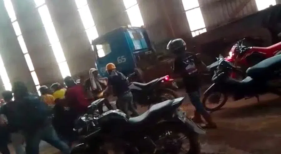 Employees react amid the chaos as Chinese and Indonesian workers clash at a nickel smelter in Morowali, Sulawesi, Indonesia in this undated social media video released 16 January 2023. (Revi Limbong via Reuters)