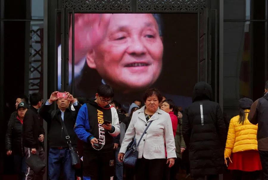 Visitors stand in front of a screen showing late Chinese leader Deng Xiaoping at an exhibition marking the 40th anniversary of China’s reform and opening up at the National Museum of China in Beijing, China, on 14 November 2018. (Thomas Peter/Reuters)