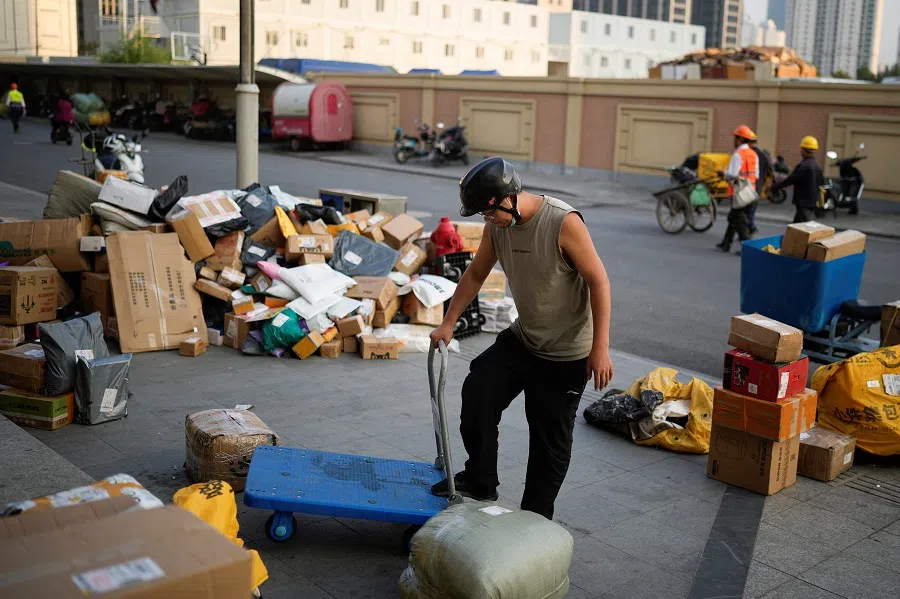 A delivery worker sorts parcels at a makeshift logistics station ahead of the Singles' Day shopping festival, following the Covid-19 outbreak in Shanghai, China, 10 November 2022. (Aly Song/Reuters)
