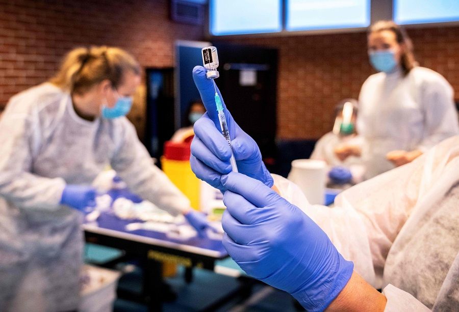 A nurse prepares a syringe with a vaccine against the Covid-19 coronavirus as residents who are over 85 years old and do not live in a nursing home are vaccinated, in Drammen, Norway, on 21 January 2021. (Ole Berg-Rusten/NTB/AFP)