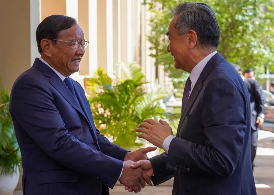 Cambodia's Foreign Minister Prak Sokhonn (left) greets China's Foreign Minister Wang Yi outside the Cambodian Ministry of Foreign Affairs and International Cooperation in Phnom Penh on 13 August 2023. (AFP)