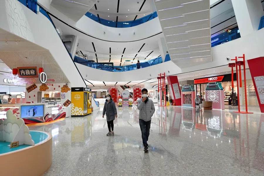 People at a mall in Beijing, March 12, 2020. (Wang Zhao/AFP)