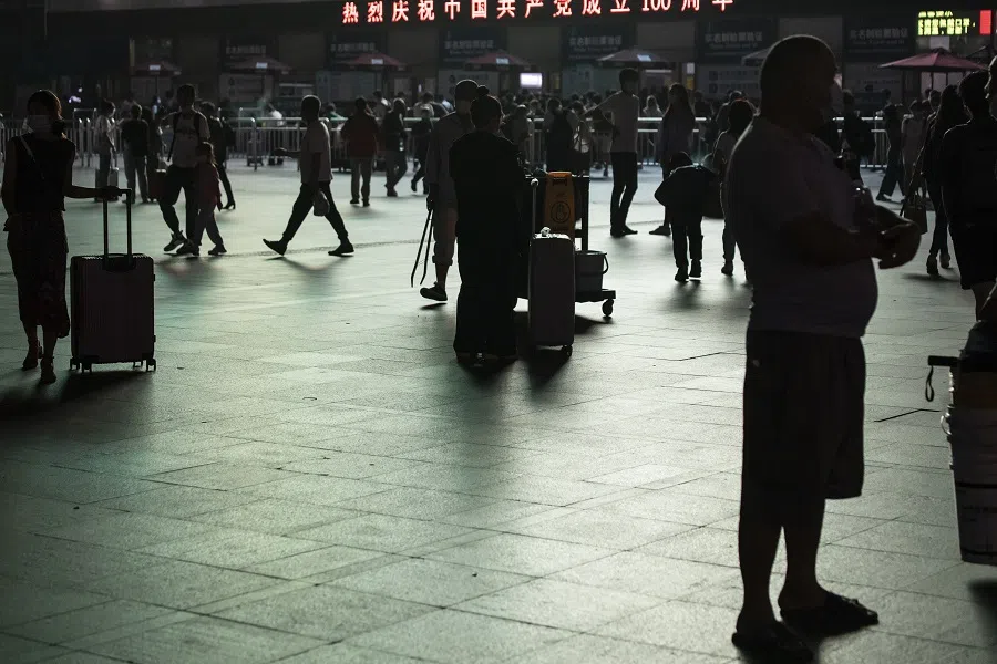 Travellers gather in the square outside Shanghai Railway Station in Shanghai, China, on 29 September 2021. (Qilai Shen/Bloomberg)