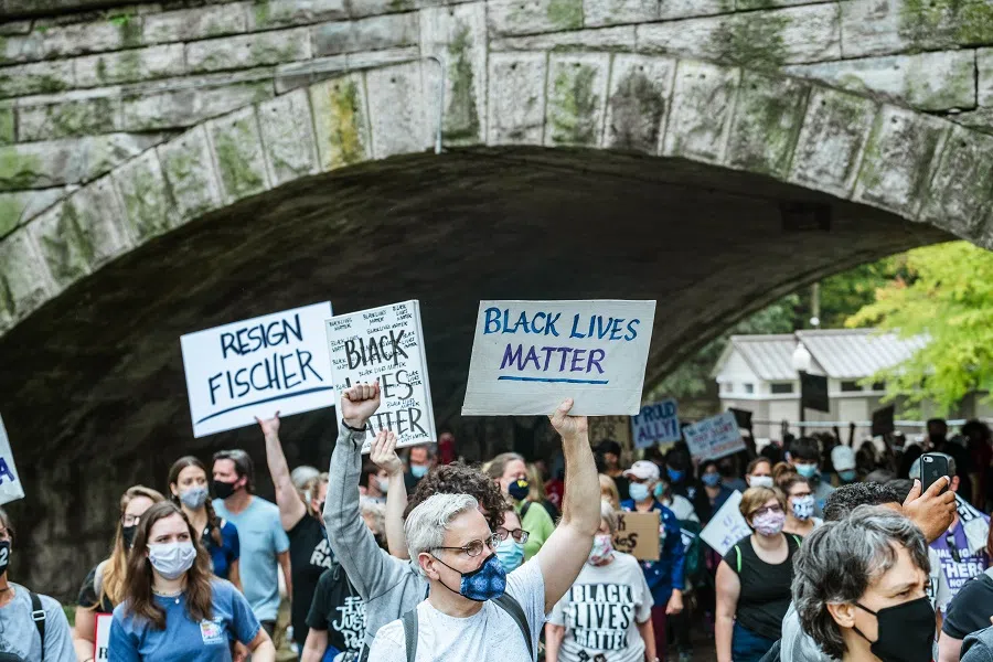 A group of protesters gather in the street during a march to the Breonna Taylor memorial at Jefferson Square Park on 10 October 2020 in Louisville, Kentucky, US. (Jon Cherry/Getty Images/AFP)