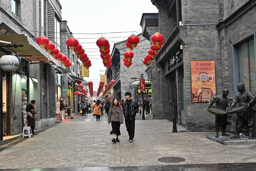 People visit the Qianmen street in Beijing on 15 November 2024.  (Adek Berry/AFP)