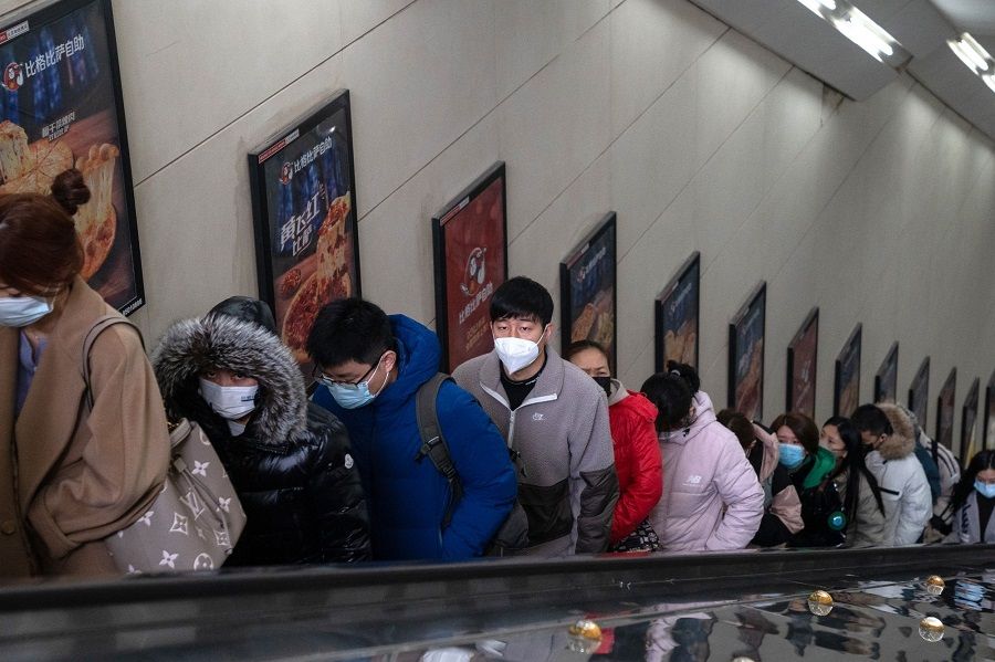 Commuters ride an escalator at a subway station in Beijing, China, on 15 February 2023. (Bloomberg)