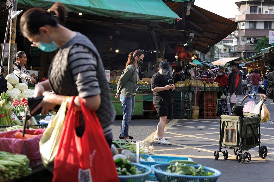 People at Hulin Market, in Taipei, Taiwan, 9 April 2023. (I-Hwa Cheng/Reuters)