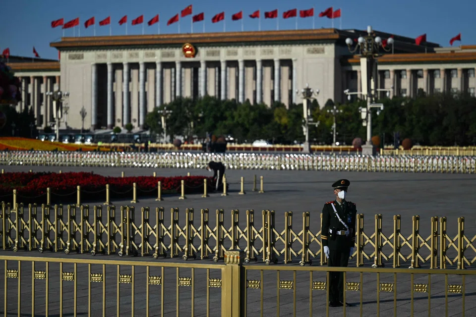 A member of the security staff keeps watch in front of the Great Hall of the People in Beijing on 16 October 2022, ahead of the opening session of the Chinese Communist Party’s 20th Party Congress. (Noel Celis/AFP)