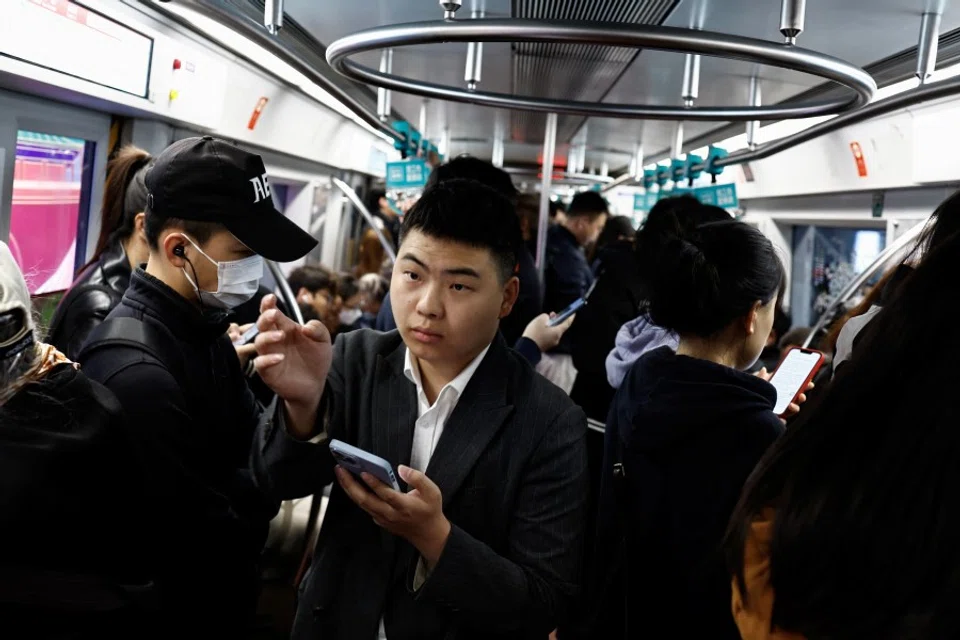 People ride a subway train during morning rush hour in Beijing, China, on 11 April 2024. (Tingshu Wang/Reuters)