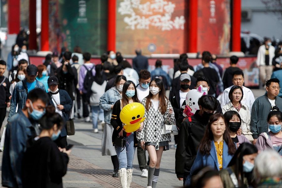 This photo taken on 4 May 2021 shows people visiting a business street in Shenyang, Liaoning province, China. (STR/AFP)