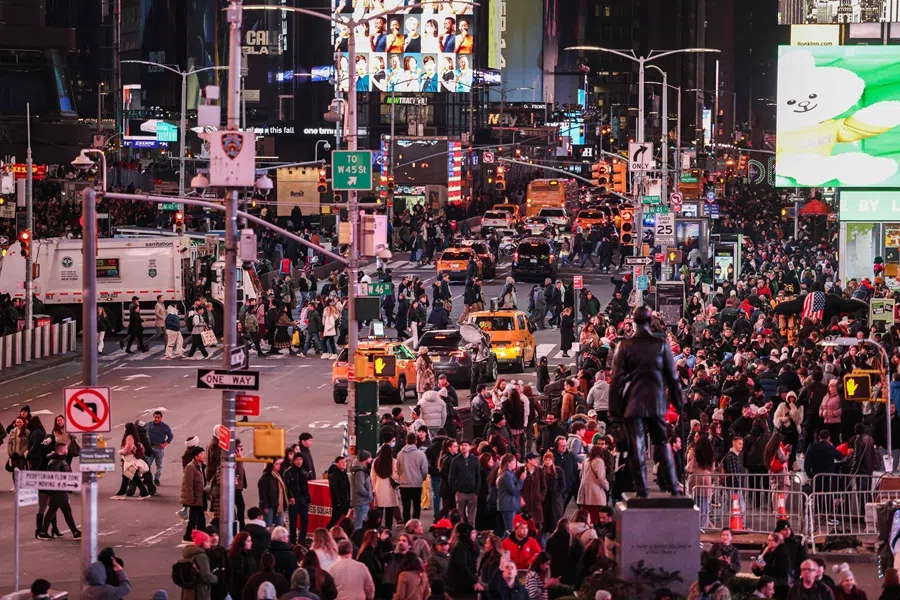 Pedestrians and vehicles move through Times Square in the Manhattan borough of New York City on 12 November 2025. (Charly Triballeau/AFP)