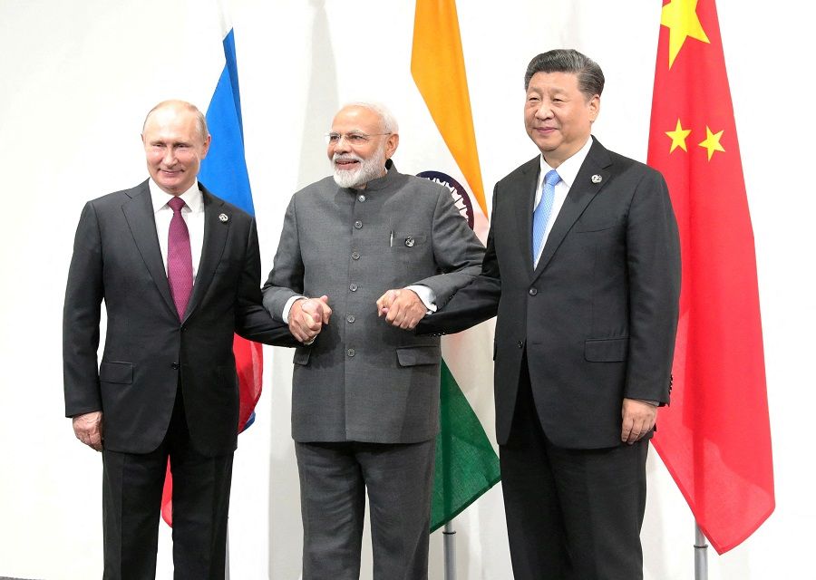 Russian President Vladimir Putin (left), Indian Prime Minister Narendra Modi (centre) and Chinese President Xi Jinping pose for a picture during a meeting on the sidelines of the G20 summit in Osaka, Japan, on 28 June 2019. (Sputnik/Mikhail Klimentyev/Kremlin via Reuters)