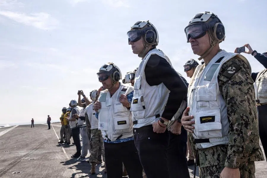 A handout photograph released by the US Navy on 8 February 2026 shows US special envoy for peace missions Steve Witkoff (left), Jared Kushner (centre) and US Navy Admiral Brad Cooper, commander of US Central Command (right), as they observe flight operations aboard Nimitz-class aircraft carrier USS Abraham Lincoln (CVN 72) in the Arabian Sea on 7 February 2026. (Sonny Escalante/US Navy/AFP)
