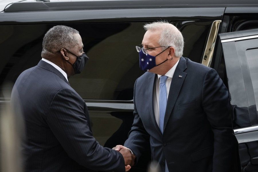 US Defence Secretary Lloyd Austin (left) shakes hands with Prime Minister of Australia Scott Morrison as he arrives to the Pentagon on 22 September 2021 in Arlington, Virginia. Australia, the US and the UK announced a security pact (AUKUS) to help Australia develop and deploy nuclear-powered submarines, in addition to other military cooperation. (Drew Angerer/AFP)