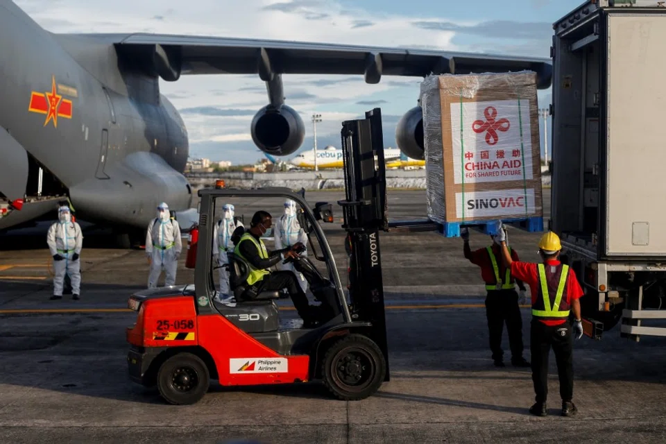 Workers load boxes with Sinovac Biotech's CoronaVac on a truck, the first shipment vaccines against the coronavirus disease (Covid-19) to arrive in the country, at Villamor Air Base in Pasay, Metro Manila, Philippines, 28 February 2021. (Eloisa Lopez/Reuters)