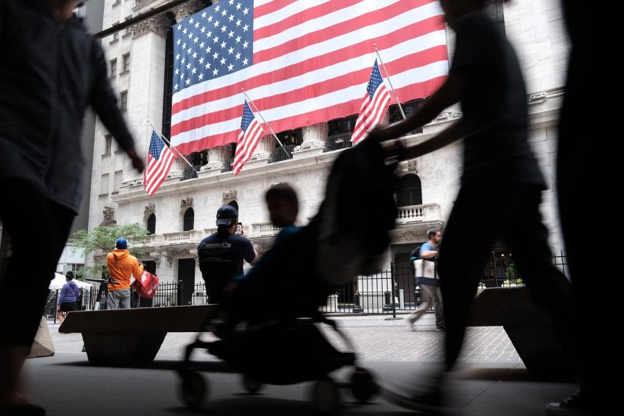 People walk by the New York Stock Exchange at the start of the trading day on 3 June 2022 in New York City. (Spencer Platt/Getty Images/AFP)