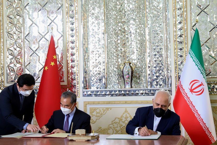 Iran's Foreign Minister Mohammad Javad Zarif and China's Foreign Minister Wang Yi sign a 25-year cooperation agreement in Tehran, Iran, 27 March 2021. (Majid Asgaripour/West Asia News Agency via Reuters)