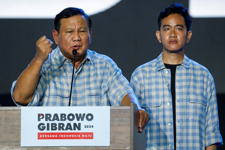 Indonesia's Defence Minister and leading Presidential candidate Prabowo Subianto delivers his speech as his running mate Gibran Rakabuming Raka, the eldest son of Indonesian President Joko Widodo and current Surakarta's Mayor, stands, as they claim victory after unofficial vote counts during an event to watch the results of the general election in Jakarta, Indonesia, on 14 February 2024. (Willy Kurniawan/Reuters)