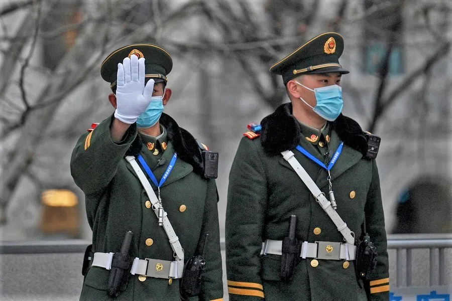 Chinese paramilitary policemen keep watch at the promenade on the Bund along the Huangpu River in Shanghai, China, on 14 February 2022. (Hector Retamal/AFP)