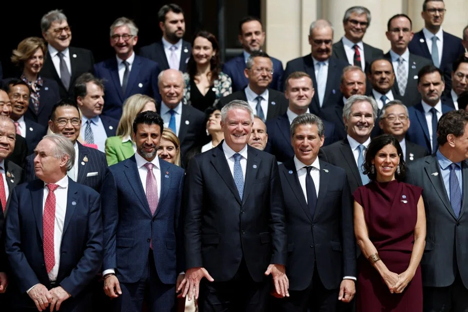 OECD secretary-general Mathias Cormann and representatives pose for a family photo after the opening ceremony of the 2025 Ministerial Council Meeting at the OECD headquarters in Paris, France, on 3 June 2025. (Benoit Tessier/Reuters)