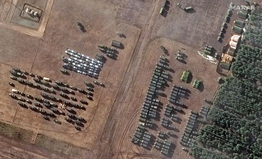 This Maxar satellite image taken and released on 22 February 2022 shows a close-up of assembled vehicles, part of a new deployment consisting of more than 100 vehicles and dozens of troop tents/shelters, at a small airfield known as the V.D. Bolshoy Bokov aerodrome near Mozyr, southern Belarus, north of the border with Ukraine. (Satellite image ©2022 Maxar Technologies/AFP)