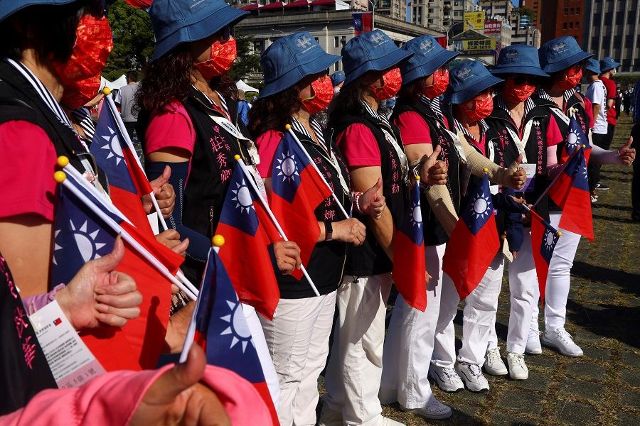 People hold Taiwan flags during the Double Tenth Day celebration in Taipei, Taiwan, 10 October 2021. (Ann Wang/Reuters)