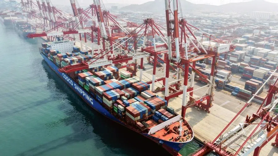 A cargo ship operated by Cosco Shipping is docked at the foreign trade container terminal of Qingdao Port, operated by Shandong Port Group, in China’s eastern Shandong province on 25 March 2026. (AFP)