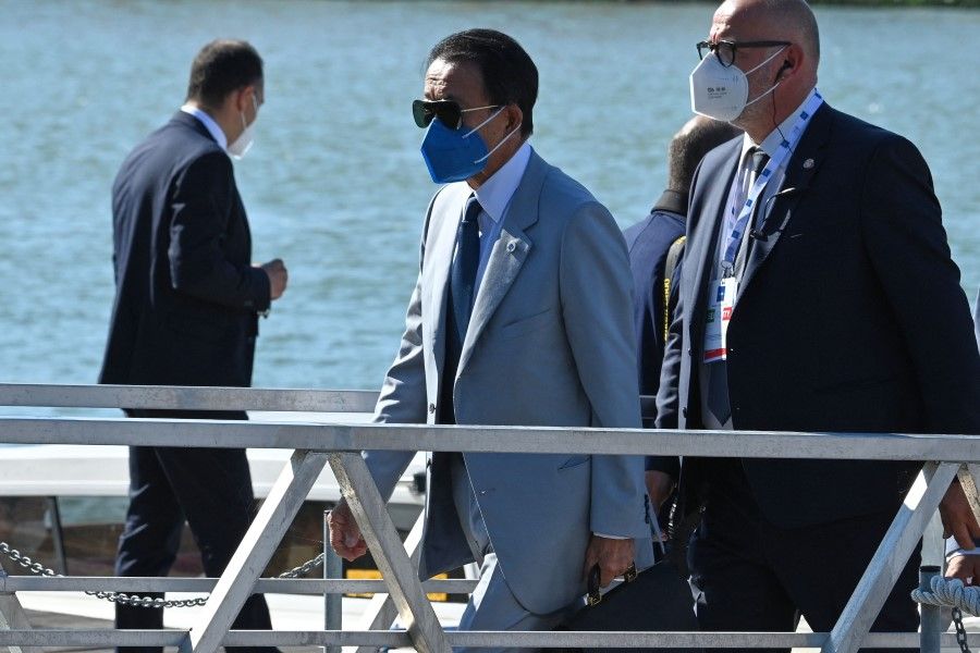Japan's Finance Minister Taro Aso (centre) is seen arriving for the G20 finance ministers and central bankers meeting in Venice on 9 July 2021. (Andreas Solaro/AFP)