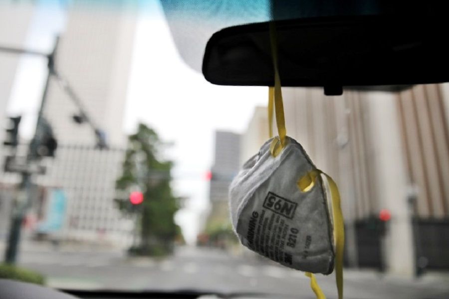 A 3M N95 respirator mask is seen hanging on a rear view mirror of a car as the spread of Covid-19 continues, in New Orleans, Louisiana, US, on 4 April 2020. (Carlos Barria/Reuters)