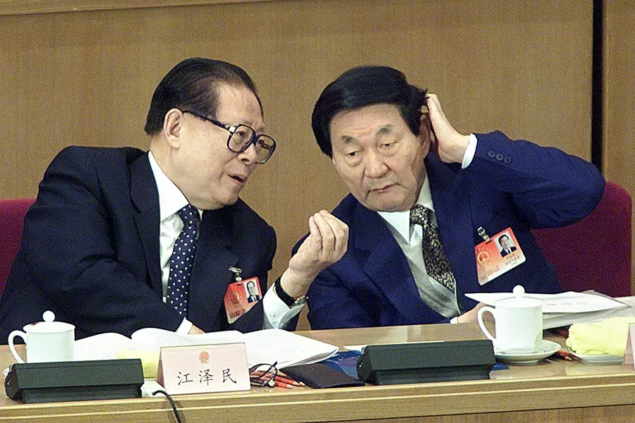 Then Chinese Premier Zhu Rongji (right) listens to then President Jiang Zemin at the National People's Congress (NPC) in the Great Hall of the People in Beijing on 6 March 2002.