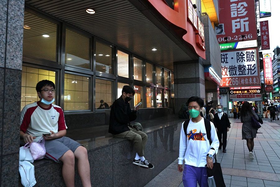 People rest and walk past a metro station in Taipei, Taiwan, 7 November 2022. (Ann Wang/Reuters)