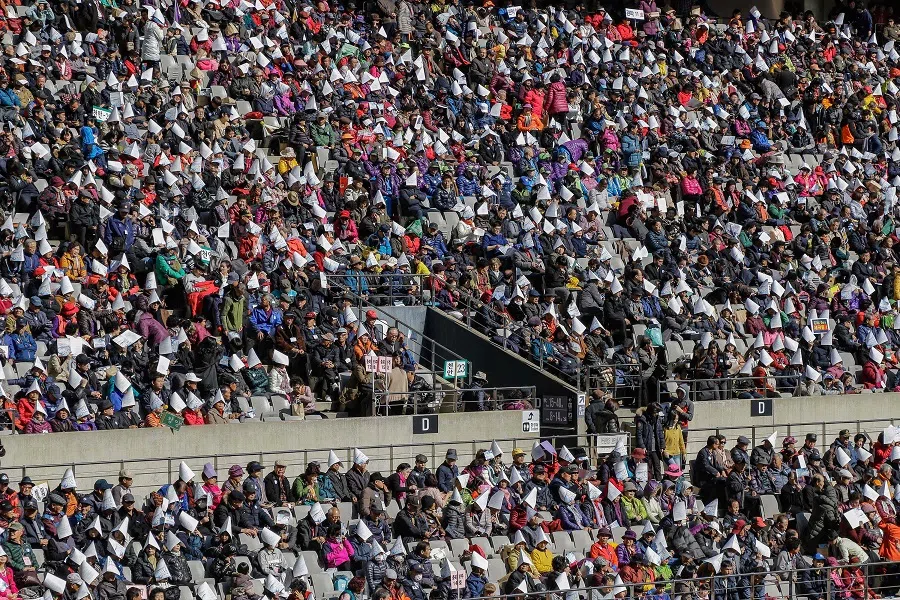 In this file photo taken on 11 November 2017, Unification Church members participate in prayers during their mass gathering for the peaceful reunification of the Korean Peninsula at the Seoul World Cup Stadium in Seoul. (Ryu Seung-il/AFP)