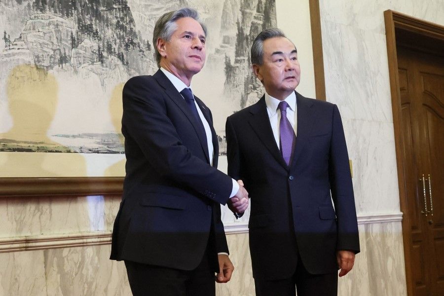 US Secretary of State Antony Blinken (left) shakes hands with China's Director of the Office of the Central Foreign Affairs Commission Wang Yi at the Diaoyutai State Guesthouse in Beijing on 19 June 2023. (Leah Millis/Reuters)