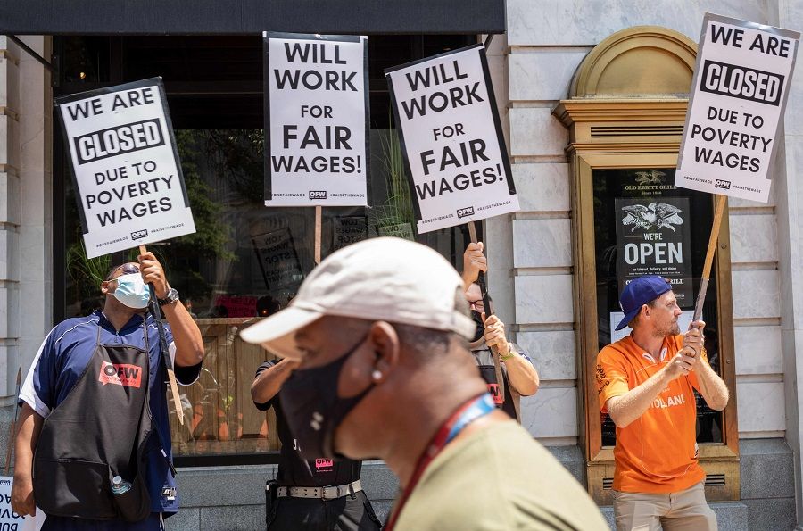 Activists take part in a protest outside of the Old Ebbitt Grill to call for a full minimum wage with tips for restaurant workers in Washington, DC on 26 May 2021. (Mandel Ngan/AFP)