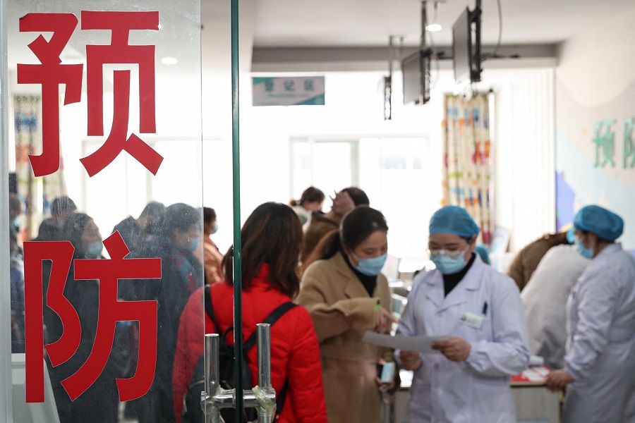 This photo taken on 21 March 2021 shows people waiting to receive the Covid-19 coronavirus vaccine at a hospital in Huai'an, Jiangsu province, China. (STR/AFP)