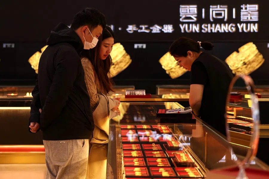 Customers shop gold jewellery at a jewellery department store in Beijing, China on 18 October 2025.