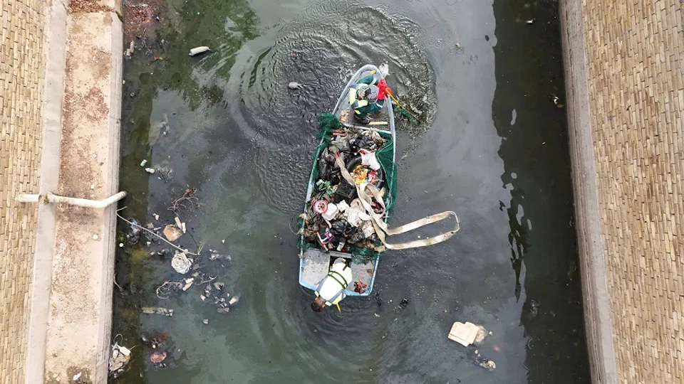A drone view shows workers clean a polluted section of the Al-Ashar River in Basra, Iraq, on 30 April 2025. (Mohammed Aty/Reuters)