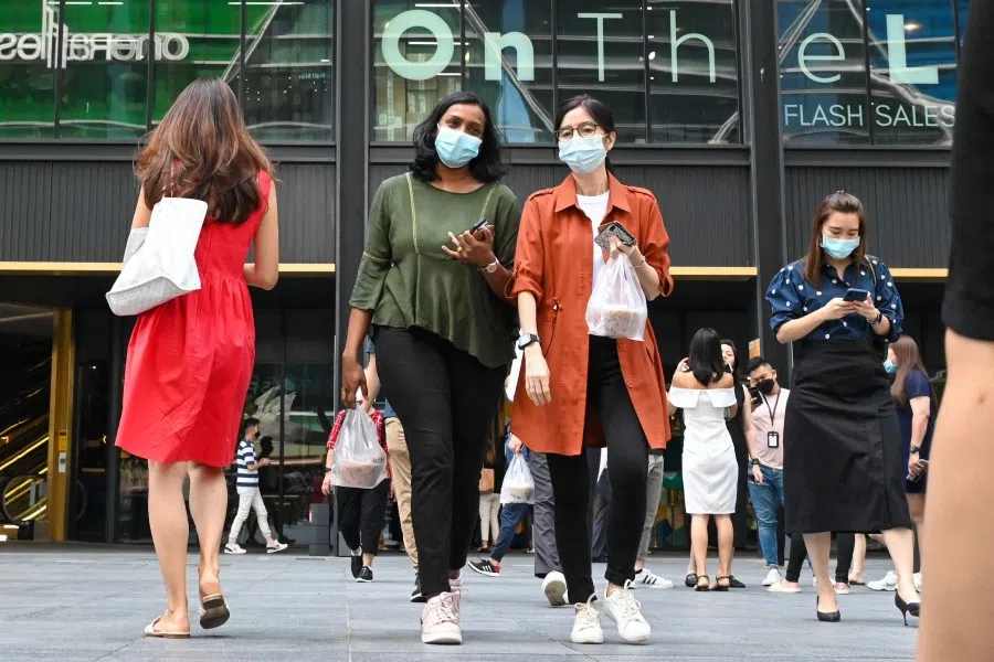 Office workers at Raffles Place financial business district in Singapore on 10 May 2022. (Roslan Rahman/AFP)