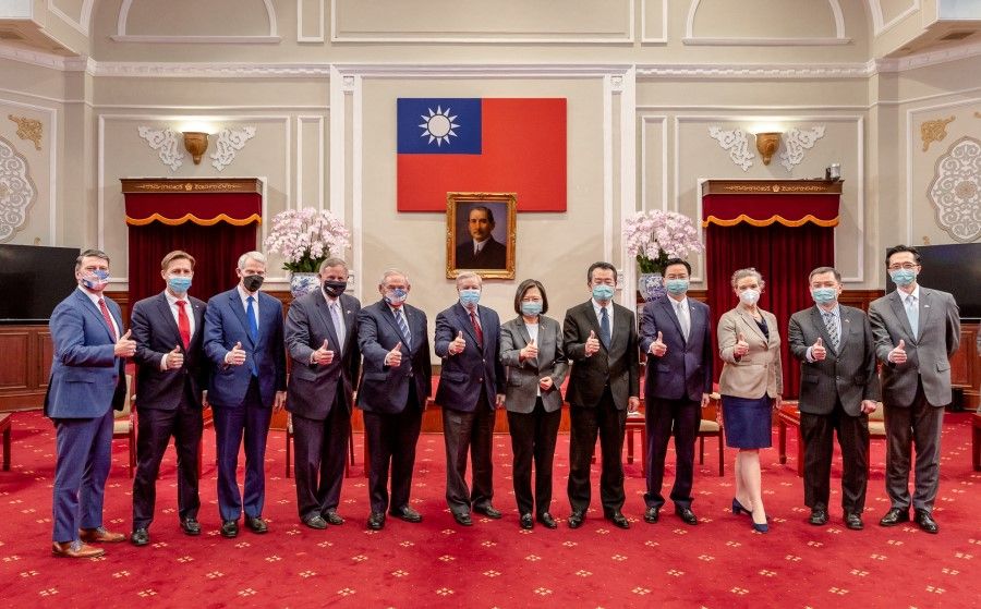 Taiwan President Tsai Ing-wen poses for a group photograph with US Senator Lindsey Graham and other US delegation members at the presidential office in Taipei, Taiwan, in this handout picture released on 15 April 2022. (Taiwan Presidential Office/Handout via Reuters)