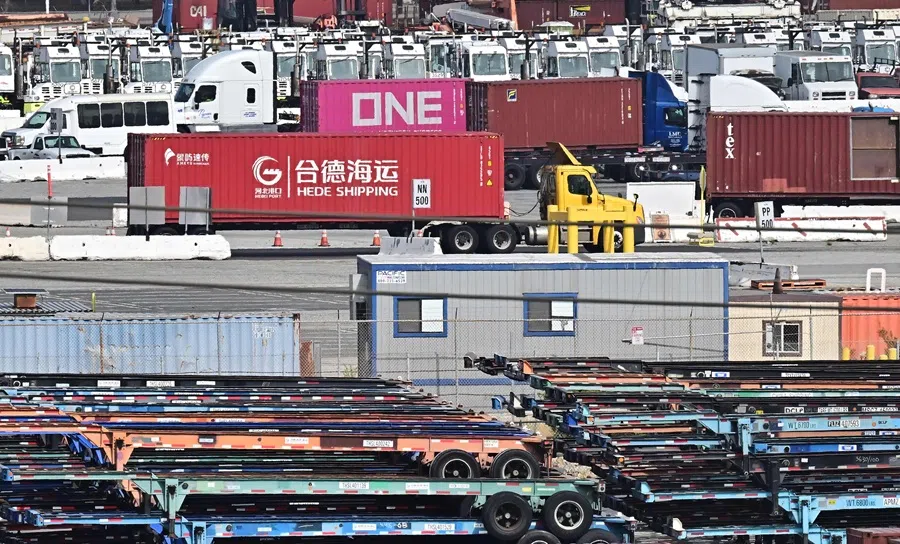 A container truck from Hede Shipping, from the Chinese state-owned Hebei Port Group, passes a row of flatbed trailers at the Port of Los Angeles in Los Angeles, California, US on 13 October 2025. (Frederic J. Brown/AFP)