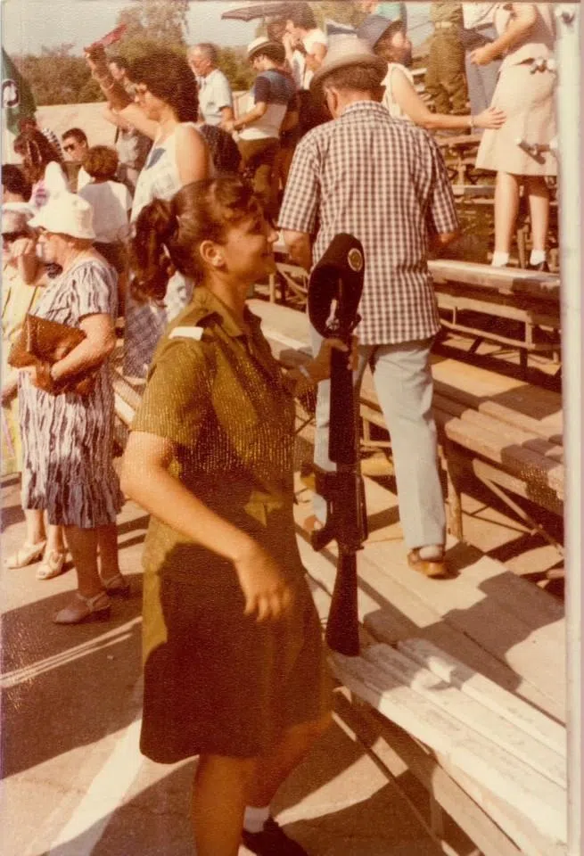 A newly enlisted female soldier interacting with her parents.