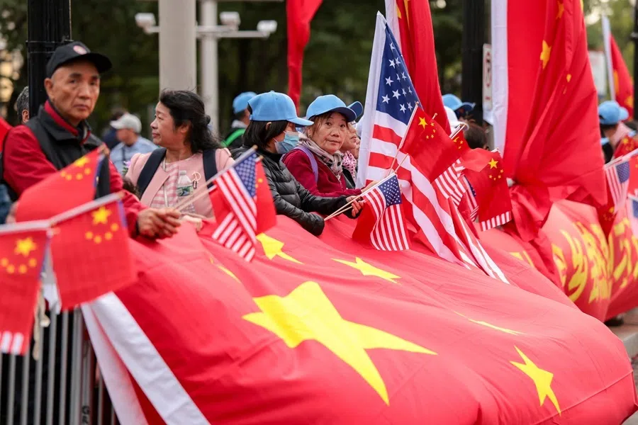 People wave Chinese and US flags near the Waldorf Astoria, on the day of Chinese President Xi Jinping's arrival in America, in Washington, DC, US, on 23 September 2026.