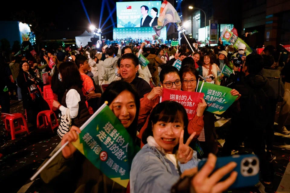 Supporters of the Democratic Progressive Party (DPP) take a selfie, as they celebrate during a rally, following the victory of Lai Ching-te in the presidential elections, in Taipei, Taiwan, on 13 January 2024. (Ann Wang/Reuters)