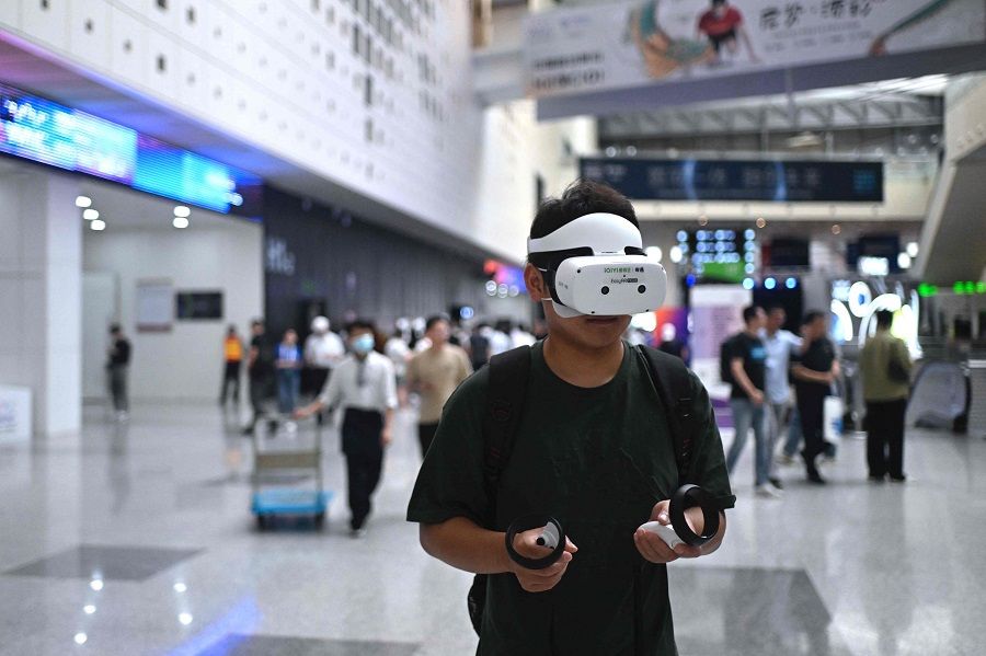 A visitor tests a VR product during the World Artificial Intelligence Conference (WAIC) in Shanghai, China, on 7 July 2023. (Wang Zhao/AFP)