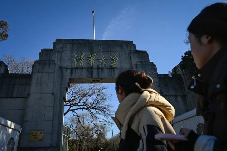 People walk past an archway of Tsinghua University in Beijing on 31 December 2025. (Wang Zhao/AFP)